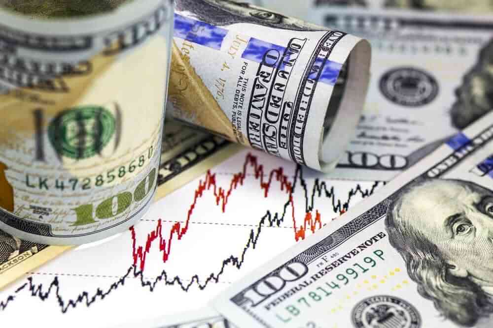 Stock price chart and US dollar bills.